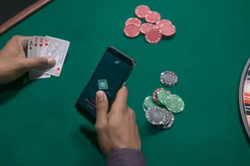 A close-up shot of golden coins falling around a spinning roulette wheel, representing immersive casino action at TK99.
